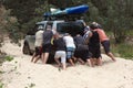 Men pushing bogged car Royalty Free Stock Photo