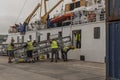 Men put into place a metal gangway on an arriving ferry in St Marys, Scilly Isles, UK Royalty Free Stock Photo