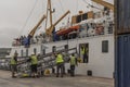 Men put into place a metal gangway on an arriving ferry in St Marys, Scilly Isles, UK Royalty Free Stock Photo