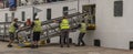 Men put into place a metal gangway on an arriving ferry in St Marys, Scilly Isles, UK Royalty Free Stock Photo