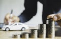 Business man putting a coin on coins stack saving bank and account for his money all in finance accounting concept Royalty Free Stock Photo