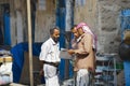 Men read newspaper at the street in Sanaa, Yemen.