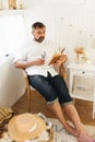 Men reading book in trailer, traveling in camper motor home