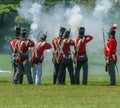 Men in Red Coats Firing Muskets