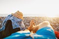 Men relaxing by sea in rocky beach Royalty Free Stock Photo