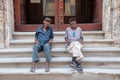 Men resting on a staircase in a building in Havana. Cuba Royalty Free Stock Photo