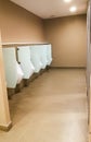 Men restroom urinals public area in department store. Clean toilet automatic water flush. modern design room and hygiene ceramic f