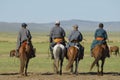 Men ride on horseback, circa Harhorin, Mongolia. Royalty Free Stock Photo