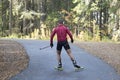 Men ride roller skis in the autumn Park