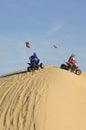 Men Riding Quad Bikes On Sand Dune In Desert Royalty Free Stock Photo