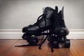 Men roller skates on hardwood floor