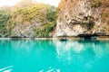 Men rowing sampan with tourist cruising along beautiful limestone rocks in Halong bay.