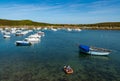 Men rowing to their anchored boat in a small dinghy in the harbor at La Conquet