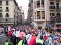 Men run from bulls in street Estafeta