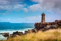 Men ruz lighthouse made of pink granit is a symbole of the Brittany coast