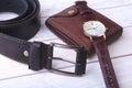 Men`s accessories for business and rekreation. Leather belt, wallet, watch and smoking pipe on wood background.. Top Royalty Free Stock Photo