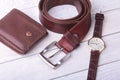Men`s accessories for business and rekreation. Leather belt, wallet, watch and smoking pipe on wood background.. Top Royalty Free Stock Photo