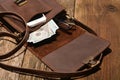Men`s accessories- a  leisure bag, money, smartphone and glasses on a wooden board background Royalty Free Stock Photo