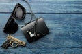 Men`s Accessories.men`s style. Glasses, business card case, headphones and a pistol-lighter on a blue wooden background. Lay lay