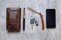 Men's Accessories , top view on a wooden wallet the phone purse, razor and e-cigarette