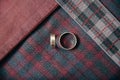 Men`s accessories - wedding rings on textile background.