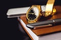 Men's accessory, golden watch, pen and mobile phone on the leather diary. Royalty Free Stock Photo