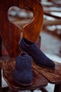 Men`s blue shoes on a wooden chair Royalty Free Stock Photo