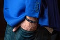 Men's bracelet on his hand, blue jacket, beautiful jewellery