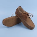 Men`s brown moccasins, loafers isolated on blue background
