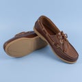 Men`s brown moccasins, loafers isolated on blue background