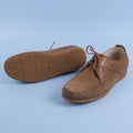 Men`s brown moccasins, loafers isolated on blue background. Side view, top Royalty Free Stock Photo