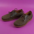 Men`s brown moccasins, loafers isolated on pink background
