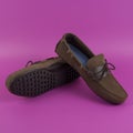 Men`s brown moccasins, loafers isolated on pink background