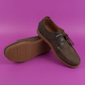 Men`s brown moccasins, loafers on pink background