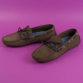 Men`s brown moccasins, loafers isolated on pink background. Side view, top view