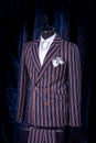 Men`s business suit on mannequin, vintage color. elegant striped suit with pocket square Royalty Free Stock Photo