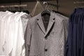 Men casual clothes in store, trendy jackets, shirts, cardigans on hangers