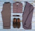 Men`s casual outfits for men clothing set with shoes, trousers, shirt on wooden background, Top view Royalty Free Stock Photo