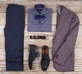 Men`s casual outfits for man clothing set with shoes, trousers, shirt, and bowtee on wooden background, Top view Royalty Free Stock Photo