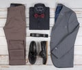 Men`s casual outfits for man clothing set with shoes, trousers, shirt, and bowtee on wooden background, Top view Royalty Free Stock Photo