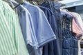 Men's clothes on hangers in a boutique. Jackets, trousers and T-shirts. Fashion & Style. Close-up. Selective focus Royalty Free Stock Photo