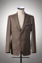 Men`s clothing, brown jacket on stand. Isolated on white background Royalty Free Stock Photo