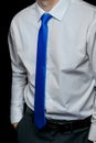 Men's clothing style fashion business man look white shirt and blue tie close-up on black background, soft focus Royalty Free Stock Photo