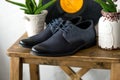 Men`s dark blue shoes on wooden table. Fahion still-life boots. Classic shoes for groom