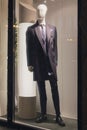 Men`s dummy in a suit in a show-window of shop