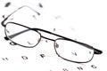 Men's eyeglasses over Snellen eye chart
