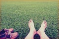 Men's feet ans shoes on the background of lush green grass ,vintage style