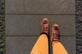 Men& x27;s feet in brown trekking winter boots. Trousers orange shade. Top view Royalty Free Stock Photo