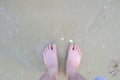 men's feet Standing on a sandy beach, at the seashore. Royalty Free Stock Photo