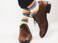 Men`s feet in stylish shoes and bright socks